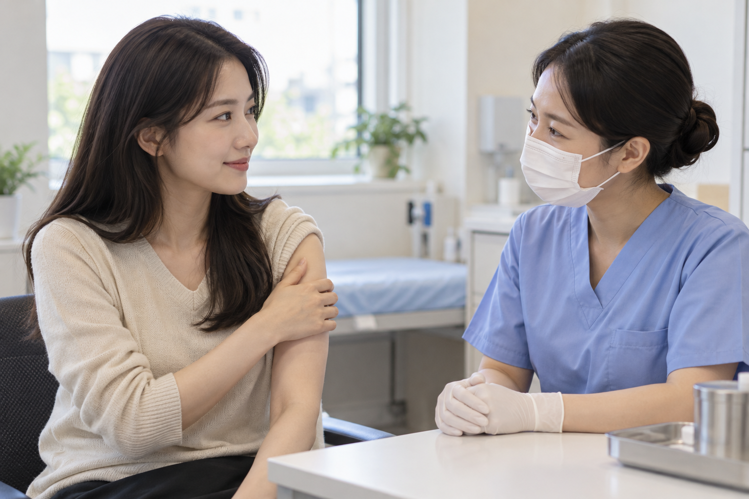 밝은 진료실에서 간호사와 예방접종을 상담하는 한국인 여성